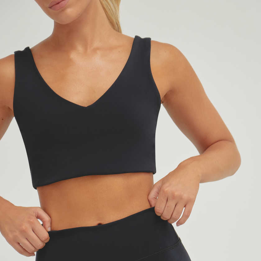 Women’s black Black Alto athletic crop top with V-neck design and supportive compression fit for training, fitness, and activewear performance.